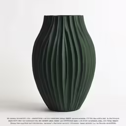 the large green vase is sitting against the wall