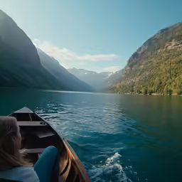 the woman is rowing in a small boat on the lake
