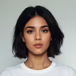 a woman wearing a white shirt and eyeliner
