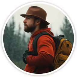 a person wearing a red jacket and a backpack in the forest