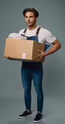 a young man is carrying boxes and looking straight ahead