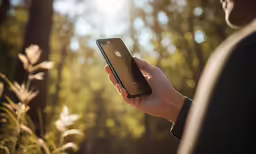 a person holding an apple phone in their hands