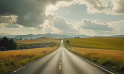 a lonely highway passing through a beautiful countryside