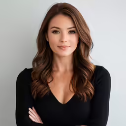 a beautiful woman in a black top posing for a picture