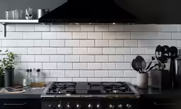 an oven and oven top with some utensils