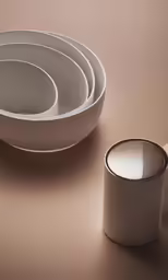 the white dishware is on a beige table