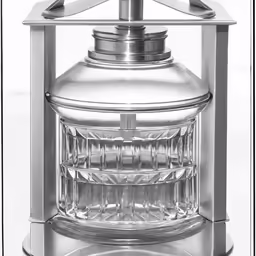 a vintage silver colored kerosen light with its glass back