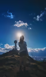 the back of a person standing on top of a hill