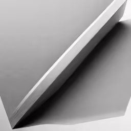 a large knife is laying next to a piece of paper