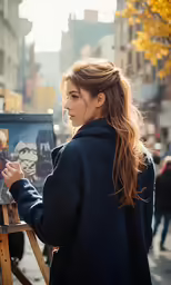 a young woman painting in an outdoor setting