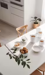 white dining room table with a lot of food sitting on it
