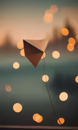 a large kite that has lights in the background