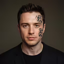 a man has multiple tattoo designs on his face