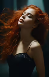 a woman with long red hair is posing in a black dress