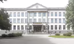 an elegant white building with lots of windows