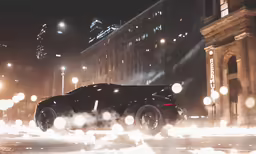 a large dark car sitting in a parking lot
