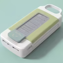 a green and white device on top of a green table