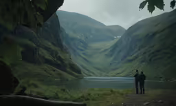 two people stand next to each other on a mountain
