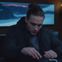 a man sitting down looking at his phone