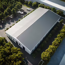 an overhead view of a building with trees around