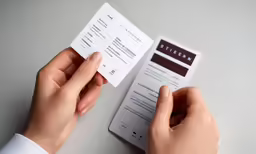 someone is holding two tickets in their hand