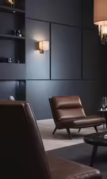 a leather chair, stool and lamp are in a room