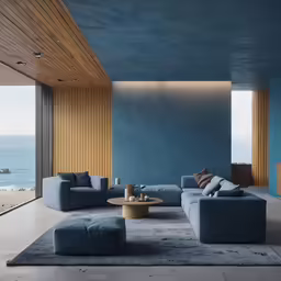 a living room with blue couches and large glass windows