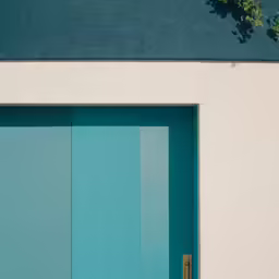 there is a very tall window with an open door