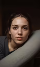 young beautiful woman standing on arm in dark room