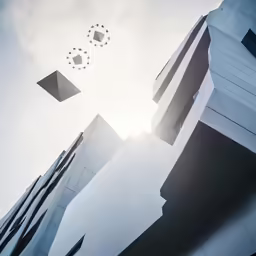 three objects flying in the air over two large buildings