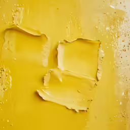 a yellow background with several layers of paint