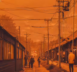people are walking down a wet sidewalk under power lines,a group of people walking down a sidewalk next to train tracks