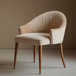 an elegant cream colored chair with wooden legs