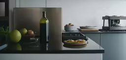 a glass bottle that is sitting on a counter