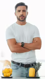 a man with a beard posing in front of a fruit bowl