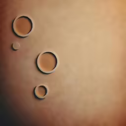 two cups of coffee sit in circles on brown paper