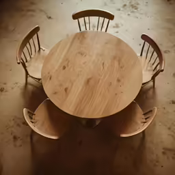 four chairs around a small round table in a room