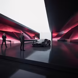 two men standing in front of a car