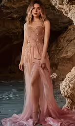 a woman is posing on the rocks in a long dress