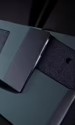 three different black and gray cell phones sitting next to each other