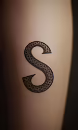 a tattoo depicting the letter s is shown