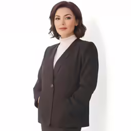the woman in the black suit is posing