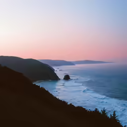 a beautiful view of a beach and mountain range