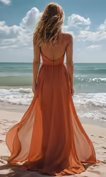a woman on the beach is looking out at the ocean