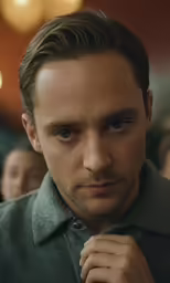 a close - up of a young man adjusting his tie