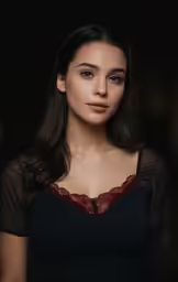 a woman wearing a black dress and red lace