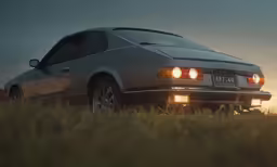 an old car is parked in a field
