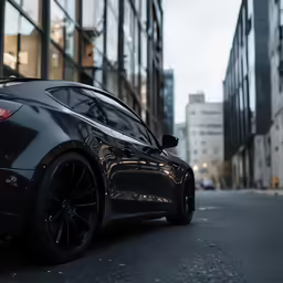 a gray sports car parked next to an empty street