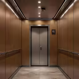 a very shiny hallway with brown walls and two elevators