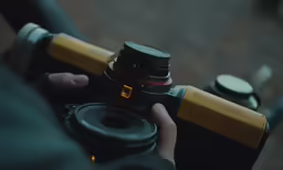a camera being held up by two hands